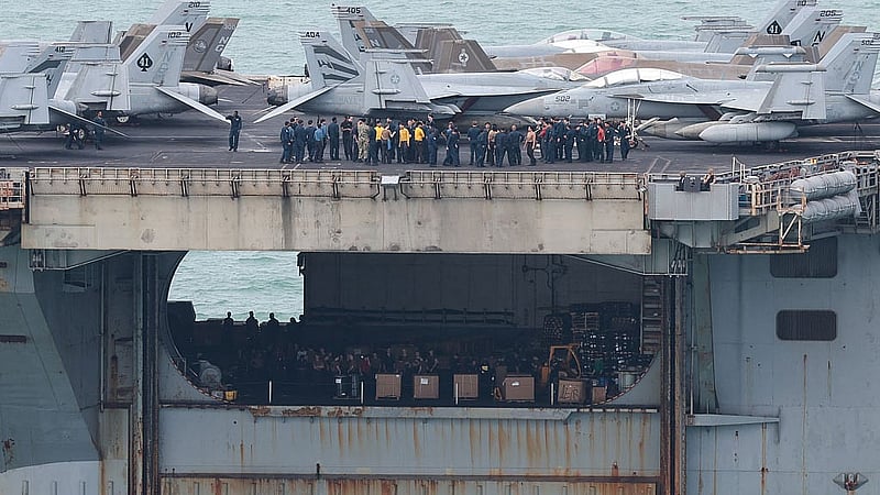 Personnel and aircraft on the deck of the US Navy Nimitz-class aircraft carrier USS Abraham Lincoln as it sails toward Laem Chabang Port before docking for a rest stop following a long deployment in the Middle East, in Chonburi province, Thailand, Sept 2, 2026. REUTERS/Chalinee Thirasupa