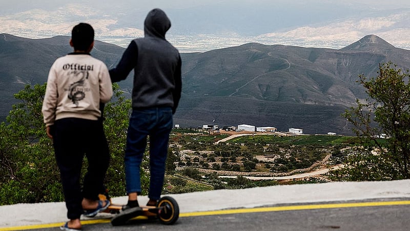 Palestinian youth look at a new Israeli settlement from the Palestinian village of Duma, near Nablus, in the Israeli-occupied West Bank, Feb 24, 2026. REUTERS