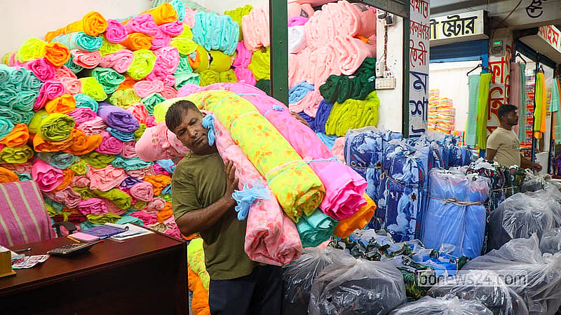 A trader prepares colourful netting fabric for wholesale at the Bhulta Gausia market in Rupganj, Narayanganj.  Photo: Shamsul Haque Ripon