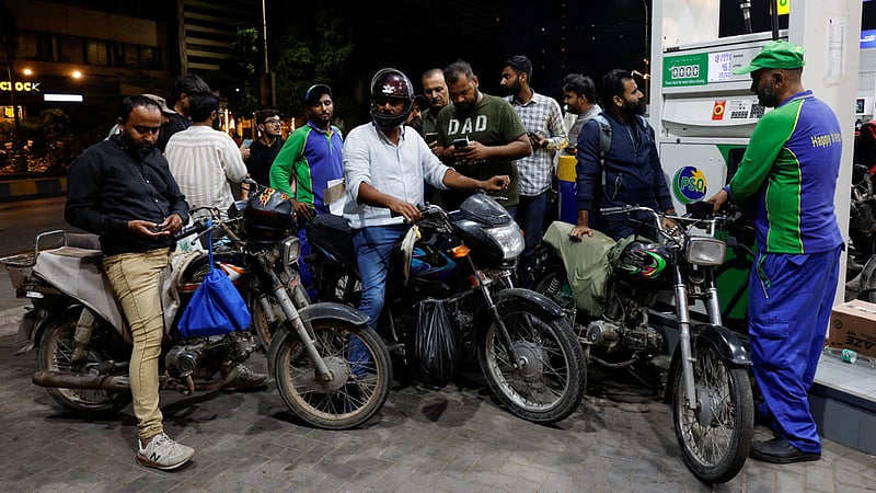 People wait to refuel their motorcycles at a petrol station following the rollout of a fuel relief scheme, which provides a fuel subsidy for eligible motorcycles, rickshaws and vehicles with engines of up to 800cc, in Karachi, Pakistan, Sept 17, 2026. REUTERS/Akhtar Soomro