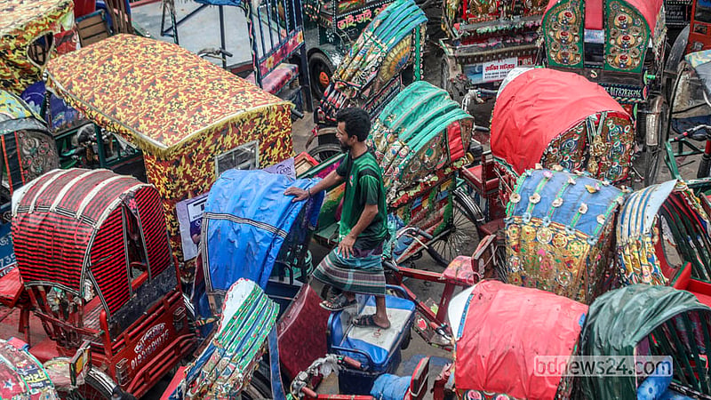 A driver searches for his rickshaw among the vehicles at the dumping station near Postogola Bridge in Dhaka. Photo: Abdullah Al Momin