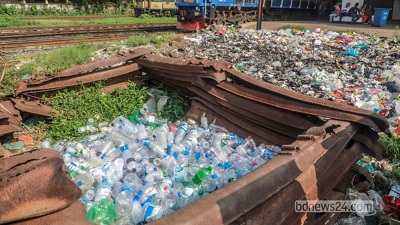 Homeless people pile up discarded plastic water bottles at the edge of a platform at Dhaka’s Kamalapur Railway Station. Photo: Abdullah Al Momin