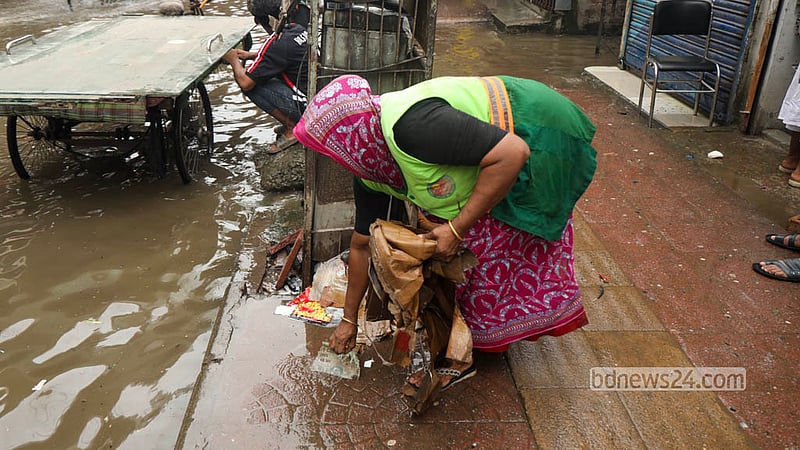City corporation workers take to the streets in Malibagh to clear the waterlogging caused by heavy rain. Shamsul Haque Ripon