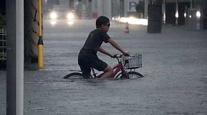 Japan typhoon rains kill two: NHK