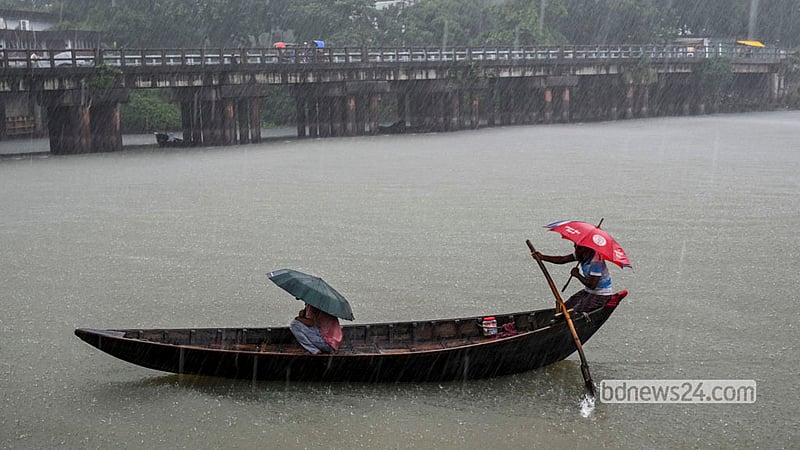 A boatman ferries passengers across the Buriganga in a heavy Ashwin downpour at Shyambazar in Old Dhaka. Photo: Mostafigur Rahman