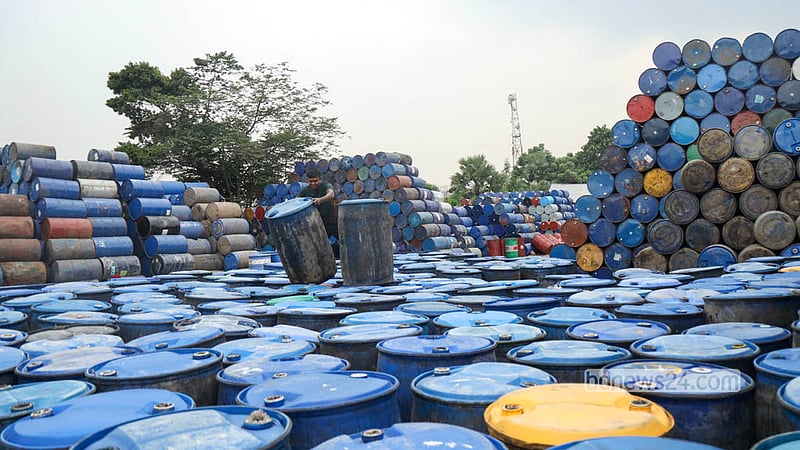 A sprawling market for used plastic drums has grown across Narayanganj’s Chashara. A worker goes about his tasks among stacks of old drums. Photo: Shamsul Haque Ripon