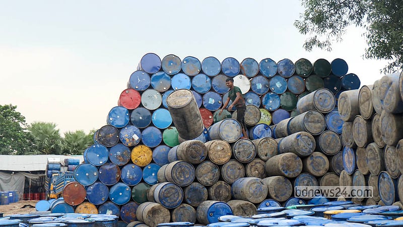 A sprawling market for used plastic drums has grown across Narayanganj’s Chashara. A worker goes about his tasks among stacks of old drums. Photo: Shamsul Haque Ripon