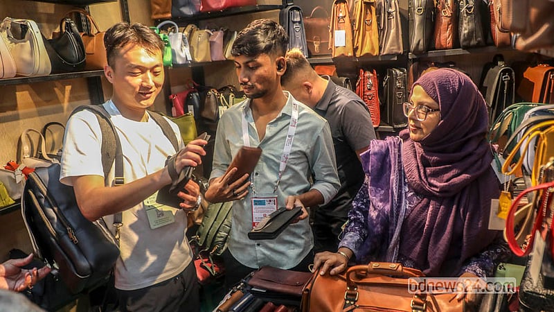Visitors browse a number of stalls during the leather and footwear industry exhibition, with many buying pieces that catch their attention.  Photo: Abdullah Al Momin