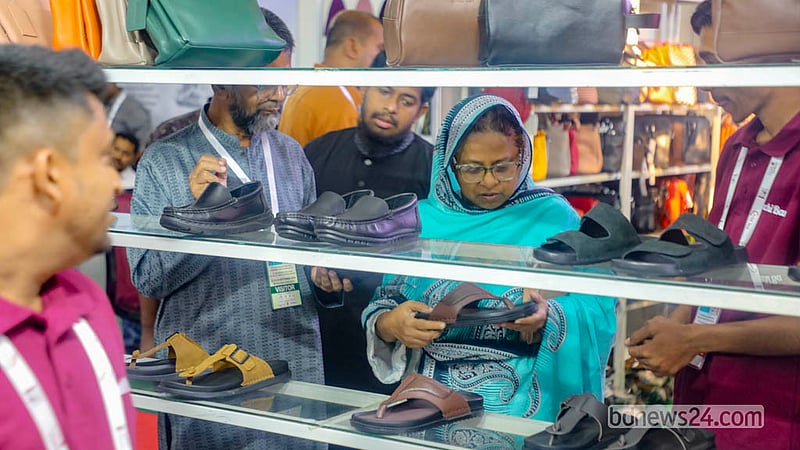A woman looks at leather handbags. The leather and footwear industry exhibition at International Convention City Bashundhara in the Kuril area of Dhaka will run until Saturday, Sept 26, 2026.   Photo: Abdullah Al Momin