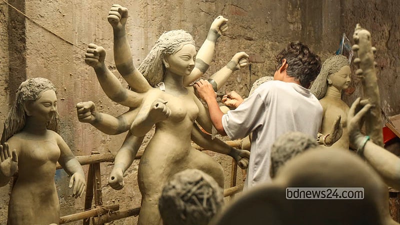 A potter carefully shapes the features of a clay idol on Northbrook Hall Road in Old Dhaka. Photo: Shamsul Haque Ripon