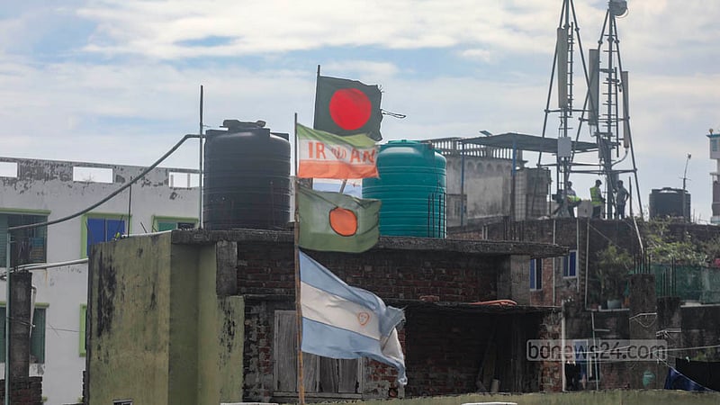 During the football World Cup, flags of different countries, including Bangladesh’s, were hoisted on rooftops across Dhaka. Months after the tournament ended, many remain in place, their colours faded and fabric torn by exposure to sun and rain. Under Bangladeshi law, displaying a torn, damaged, or faded national flag is an offence. Photo: Abdullah Al Momin