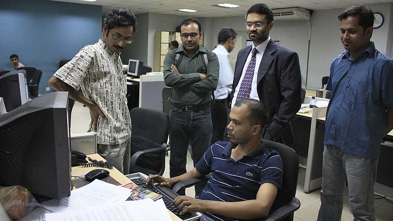 bdnews24.com Editor-in-Chief Toufique Imrose Khalidi with colleagues at the organisation’s headquarters.