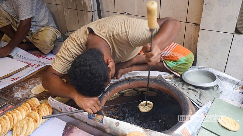 Fresh bakarkhani is lifted from the oven at a shop on Nazimuddin Road in Old Dhaka. Photo: Shamsul Haque Ripon