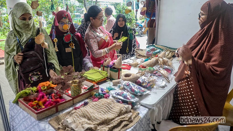 Visitors browse stalls at the jute products fair, with some stopping to shop for items they like.  Photo: Abdullah Al Momin