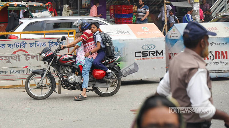 A student rides pillion on a motorcycle without wearing a helmet at Malibagh intersection. Photo: Shamsul Haque Ripon