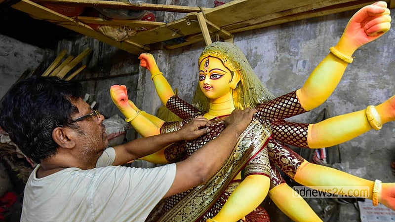 At the Zamindar Bari Puja Mandap at Old Dhaka’s Banglabazar, deft brushstrokes bring the Hindu goddess to life in exquisite detail. Photo: Shamsul Haque Ripon