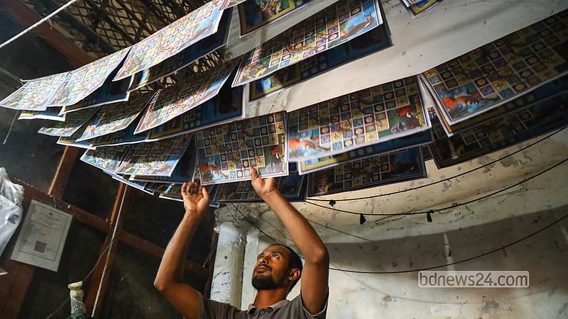 A worker lets a glued-together Ludo board dry in the sun on the roof of an old building in Chhoto Katra in Old Dhaka’s Chawkbazar. Photo: Shamsul Haque Ripon