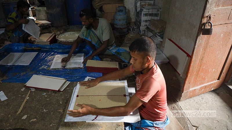 Craftsmen are busy making Ludo boards at the Quader Ludo Factory in Chhoto Katra in Old Dhaka’s Chawkbazar. These Ludo boards are made by applying printed paper to thick hardboard in several steps. Photo: Shamsul Haque Ripon