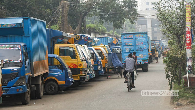 Trucks and covered vans parked carelessly across the road in Dhaka’s Tejgaon have narrowed the route for traffic. Photo: Shamsul Haque Ripon