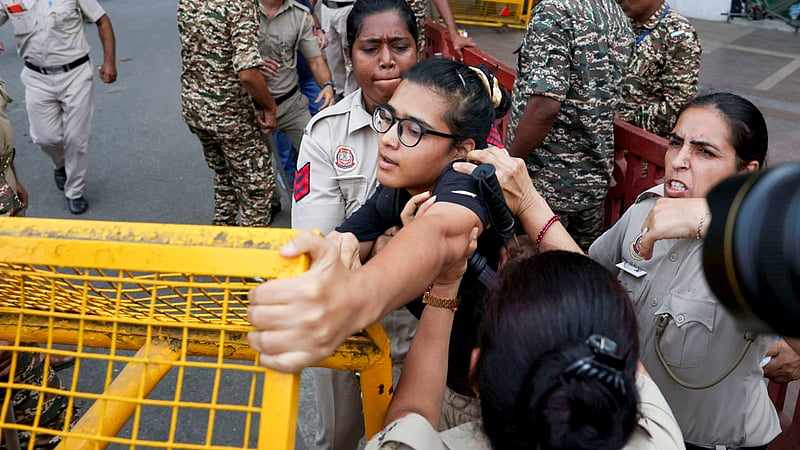 Police officers scuffle with national president of the All India Students' Association (AISA) Neha Bora, as she is detained during a protest demanding the resignation of India's Chief Election Commissioner Gyanesh Kumar, in New Delhi, India, October 11, 2026. Photo: Reuters
