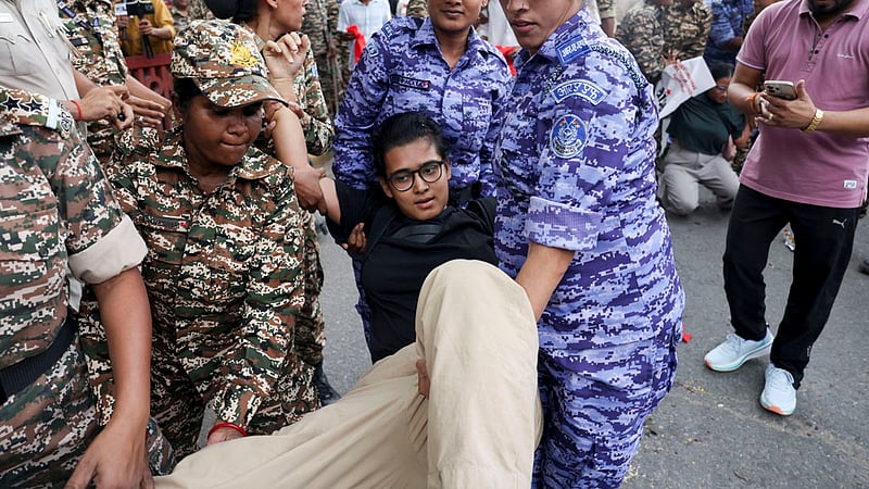 Police officers carry national president of the All India Students' Association (AISA) Neha Bora as she is detained during a protest seeking the resignation of India's Chief Election Commissioner Gyanesh Kumar, in New Delhi, India, October 11, 2026. Photo: Reuters