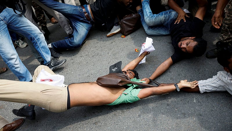 Protesters are detained by security personnel during a protest by the Cockroach Janta Party (CJP) seeking the resignation of India's Chief Election Commissioner Gyanesh Kumar, near the protest site in New Delhi, India, October 11, 2026. Photo: Reuters