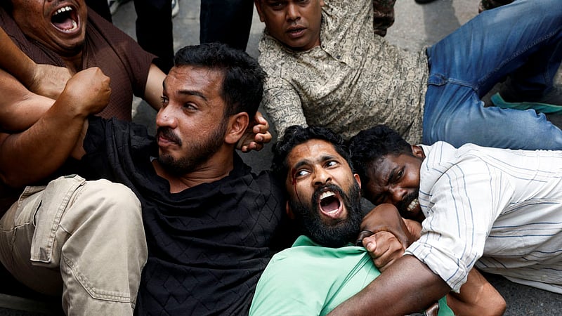 Protesters react as they are detained by security personnel during a protest by the Cockroach Janta Party (CJP) seeking the resignation of India's Chief Election Commissioner Gyanesh Kumar, near the protest site in New Delhi, India, October 11, 2026. Photo: Reuters
