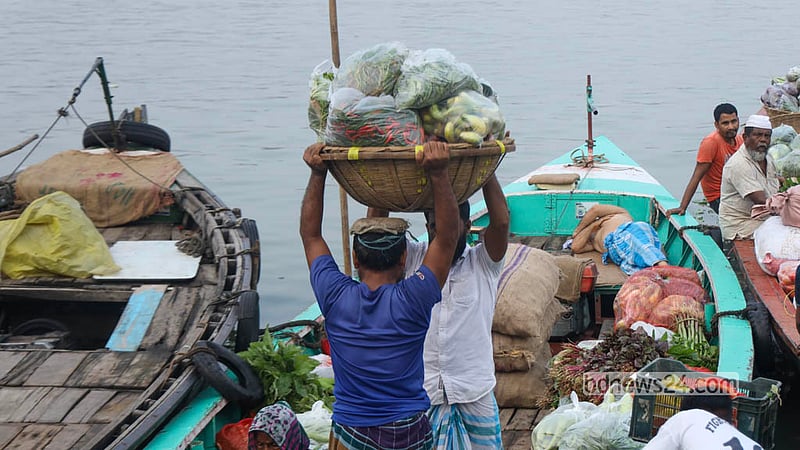 Retailers and workers are busy trading for various types of vegetables from the Shyambazar wholesale warehouse in Old Dhaka before loading them onto trawlers. Photo: Shamsul Haque Ripon