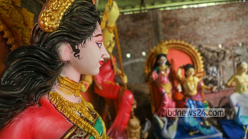 An artisan adds the final strokes of colour to bring Goddess Durga to life ahead of the festival celebrating her. Photo: Abdullah Al Momin