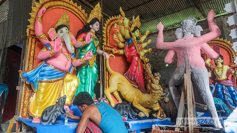 Artisans put the finishing touches to a Durga idol at Dhaka’s Ramna Kali Temple ahead of the Durga Puja. Photo: Abdullah Al Momin
