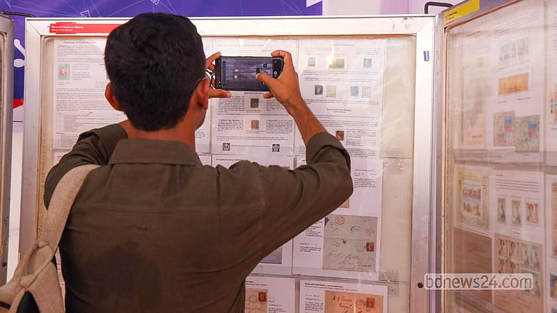 Visitors browse rare and historic postage stamps arranged on display boards at the exhibition at Dhaka University’s TSC on Monday, Oct 12, 2026, marking World Post Day. Photo: Shamsul Haque Ripon