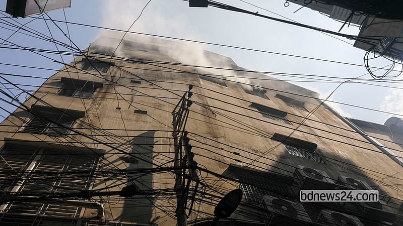 The fire at Munsur Khan Plaza in Old Dhaka’s Chawkbazar was brought under control on the morning of Tuesday, Oct 13, 2026, but smoke was still seen rising from the scene in the afternoon. Photo: Shamsul Haque Ripon