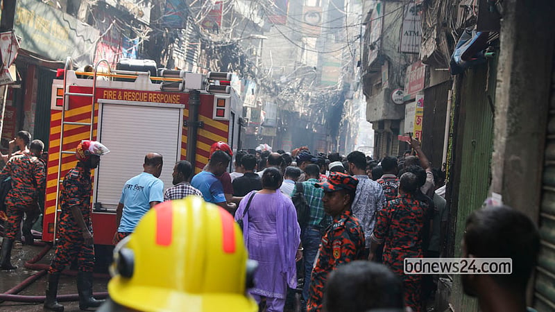 The fire at Munsur Khan Plaza in Old Dhaka’s Chawkbazar was brought under control on the morning of Tuesday, Oct 13, 2026, but smoke was still seen rising from the scene in the afternoon. Fire Service personnel worked to extinguish it. Photo: Shamsul Haque Ripon