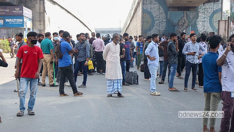 Passengers headed to the airport face a lengthy delay as workers from several garment factories protest by blocking a highway in Dhaka’s Uttara on Wednesday, Oct 14, 2026 to demand a wage hike. Photo: Shamsul Haque Ripon