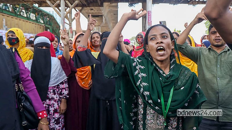 Workers from several garment factories protest by blocking a highway in Dhaka’s Uttara on Wednesday, Oct 14, 2026 to demand a hike in the minimum wage and an increase in other wages and allowances. Photo: Shamsul Haque Ripon