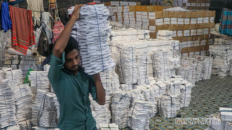 Neatly stacked sheets of printed pages await binding as production of secondary-level textbooks for the 2027 academic year continues in Dhaka’s Matuail. Photo: Abdullah Al Momin