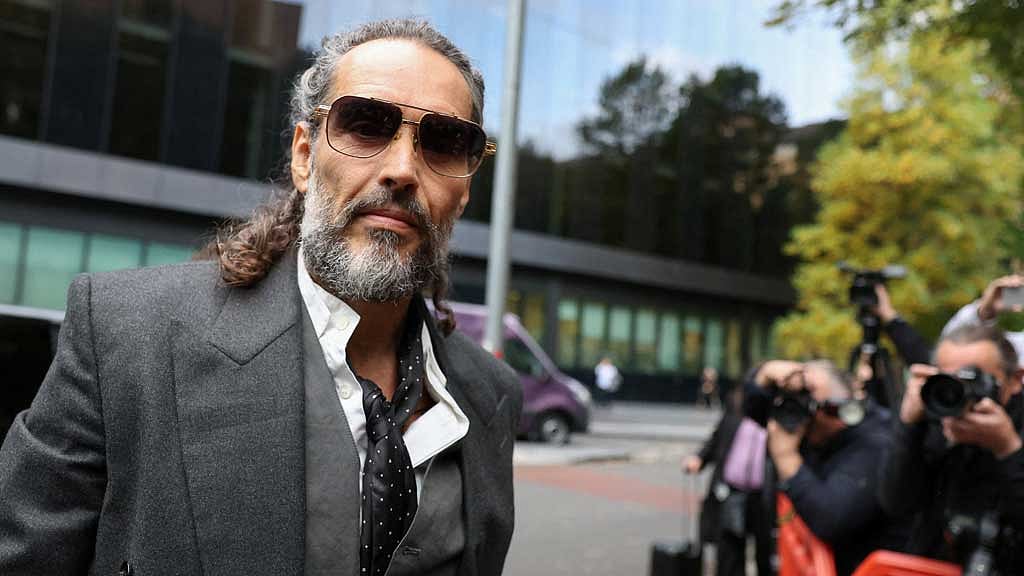 Comedian Russell Brand accuser says she blamed herself for alleged rape in 1999