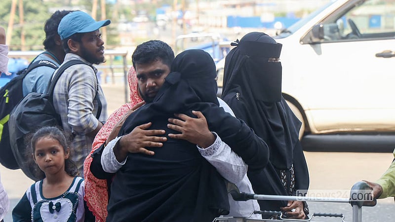 An expatriate worker hugs his loved ones at Dhaka's Shahjalal International Airport in an emotional farewell before he leaves the country. Photo: Shamsul Haque Ripon