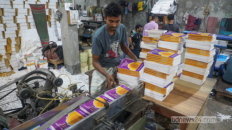 With the new year fast approaching, workers press on with the task of producing textbooks, racing to ensure students receive their new books on the first day of the year. Photo: Abdullah Al Momin
