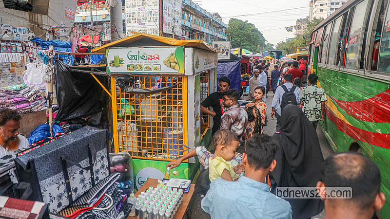 People suffer in traffic jams as hawker stalls encroach on the road in Dhaka's New Market area. Photo: Abdullah Al Momin