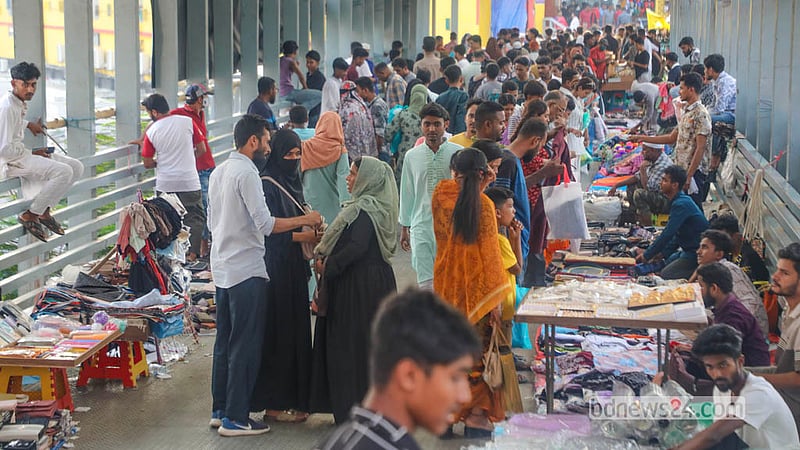 Hawkers occupy both sides of a foot overbridge in Dhaka's New Market area, displaying their wares. Photo: Abdullah Al Momin