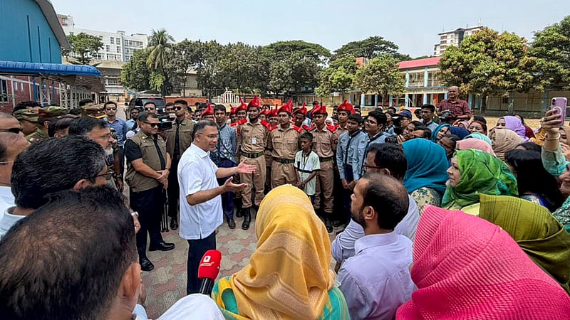 Prime Minister Tarique Rahman speaks with teachers and students during a visit to Mirpur Cantonment Public School and College in Dhaka on Saturday, Oct 17, 2026. Photo: PMO