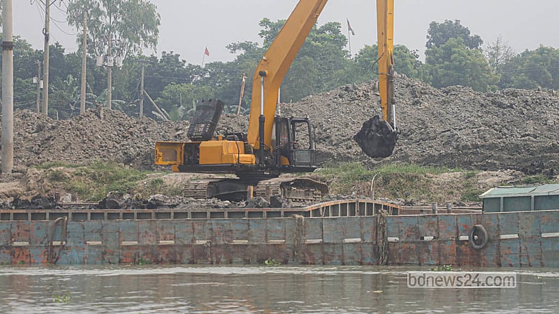 An excavator unloads clay brought by boat into a brickmaking yard at Keraniganj’s Zazira.   Photo: Abdullah Al Momin