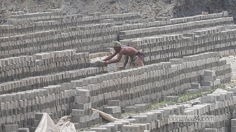A worker lays bricks out to dry in the sun at a kiln at Keraniganj’s Zazira.   Photo: Abdullah Al Momin
