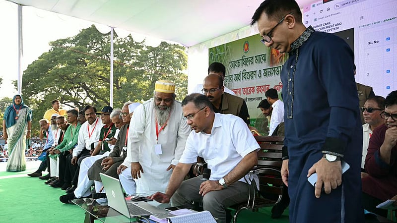 Prime Minister Tarique Rahman uses a computer to transfer financial assistance directly to sugarcane farmers’ bank accounts at a rally at Haji Muhammad Mohsin Government High School in Rajshahi on Monday, Oct 20, 2026. Photo: PMO