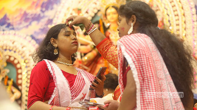 Devotees apply vermilion to one another's foreheads during the traditional Sindoor Khela ritual at Dhakeshwari National Temple on Bijoya Dashami. Photo: Shamsul Haque Ripon