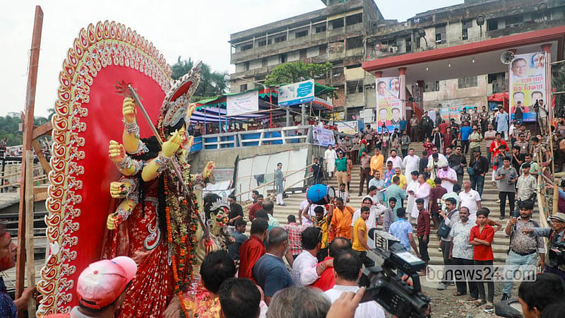 Devotees bid farewell to Goddess Durga as her idols are immersed in the Buriganga River at Wais Ghat in Dhaka. Photo: Abdullah Al Momin