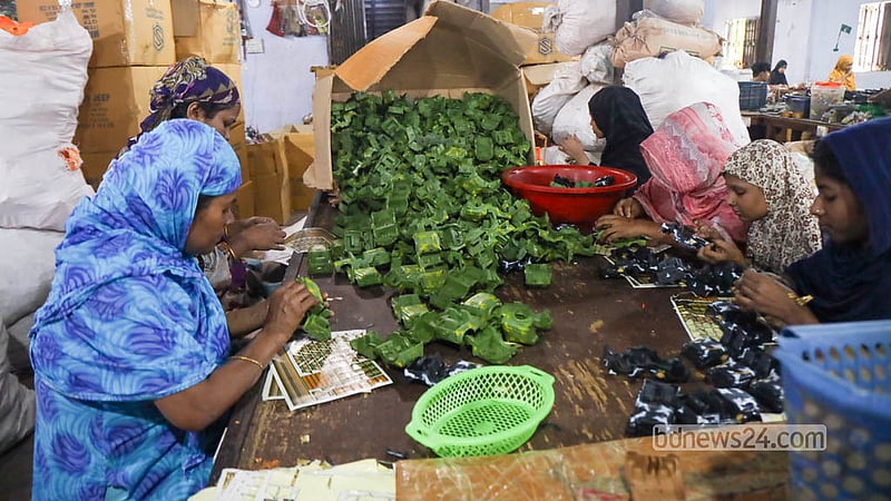 Craftswomen work to make a range of colourful plastic cars for children. Photo: Shamsul Haque Ripon