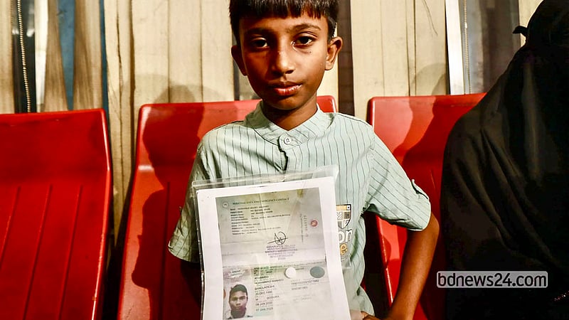 A child of Shahed Ahmed waits at Hazrat Shahjalal International Airport in Dhaka for the arrival of his father's body, Oct 23, 2026. Photo: Shamsul Haque Ripon