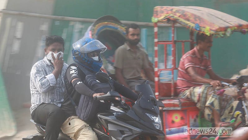 Commuters have few options to avoid dust while travelling from Babubazar to Gabtoli, with many wearing face masks to protect themselves from heavy dust along the route. Photo: Abdullah Al Momin